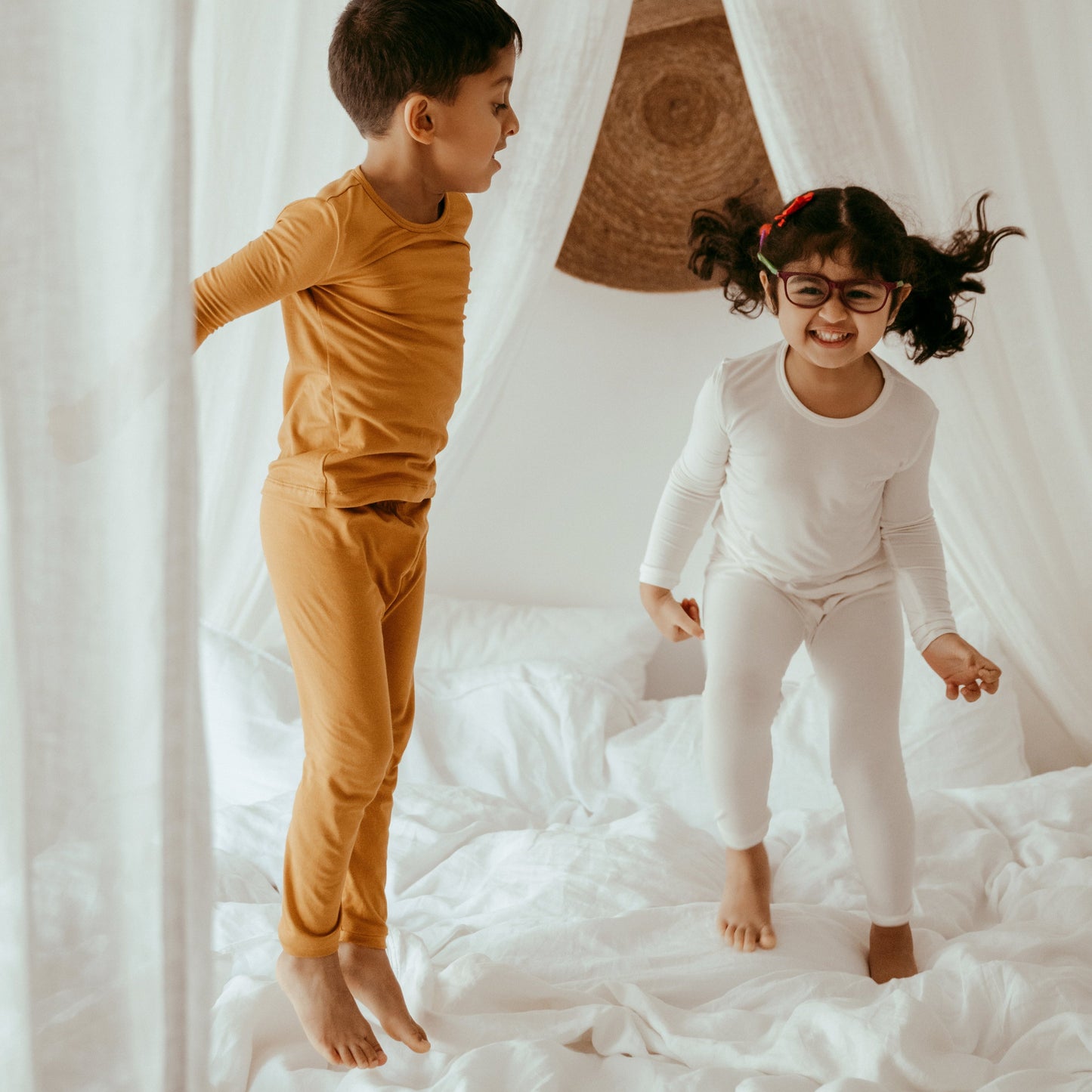 Anvi Baby PJs - White - juping on the bed