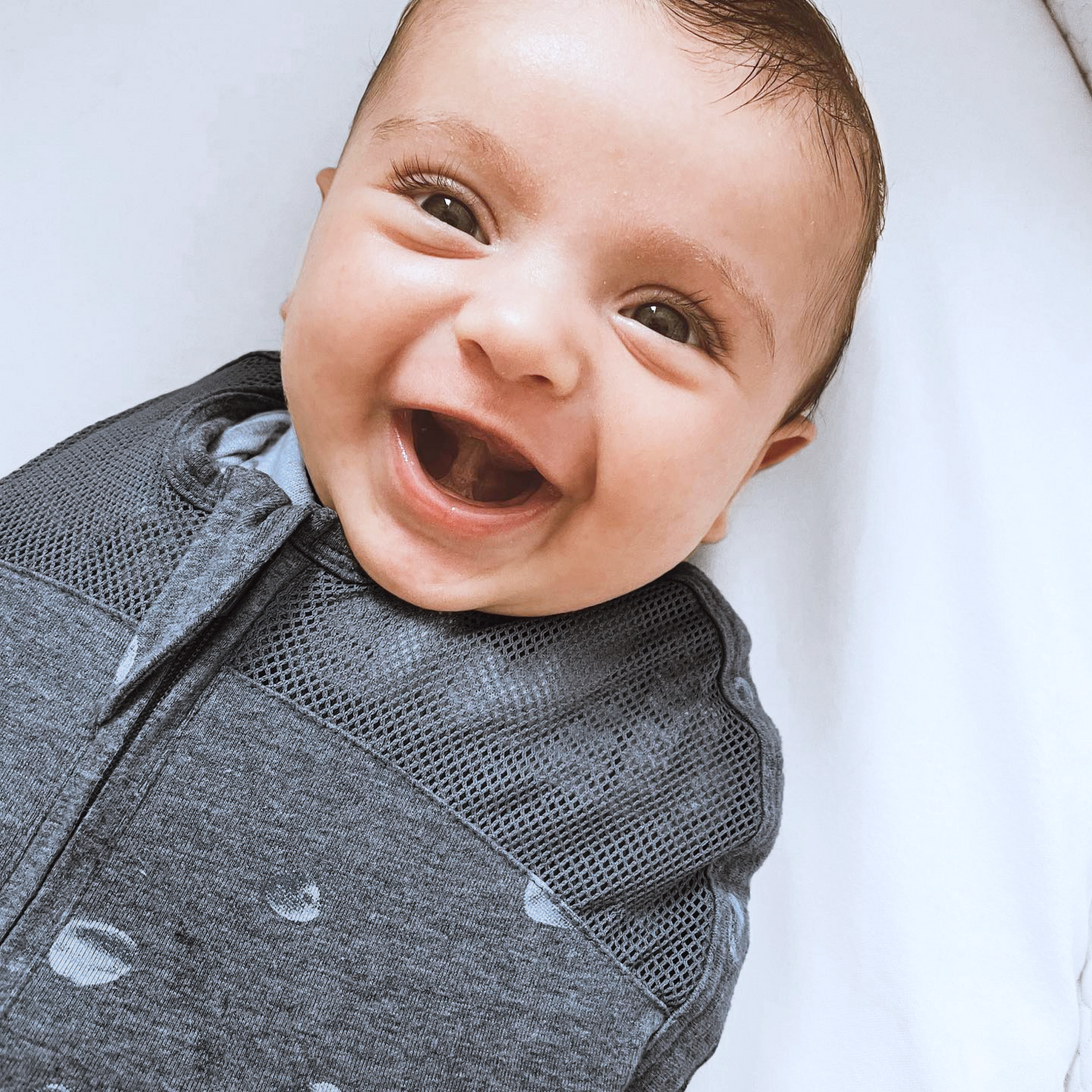 Happiest Baby - Sleepea - Grey Planets - baby laughing close up