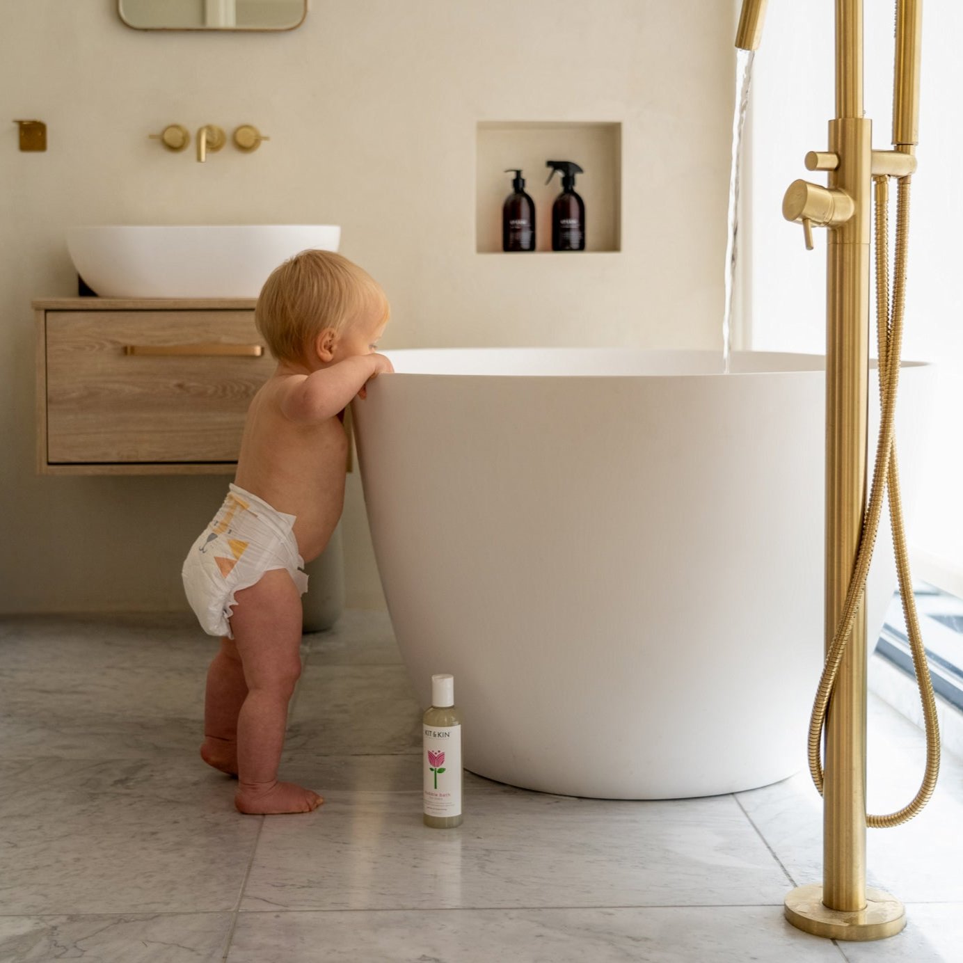 Kit & Kin Bubble Bath - baby holding bath