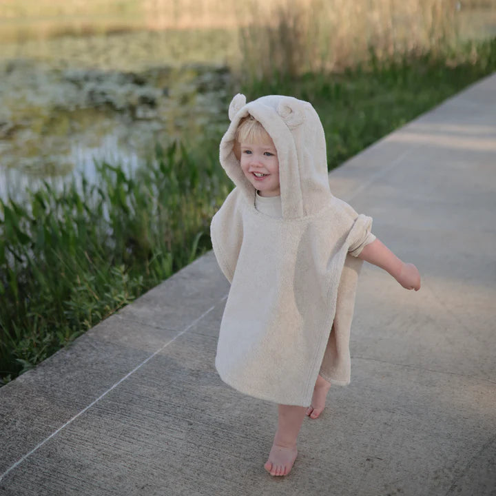 Mushie - Bear Poncho Towel - Fog - little boy smiling outside