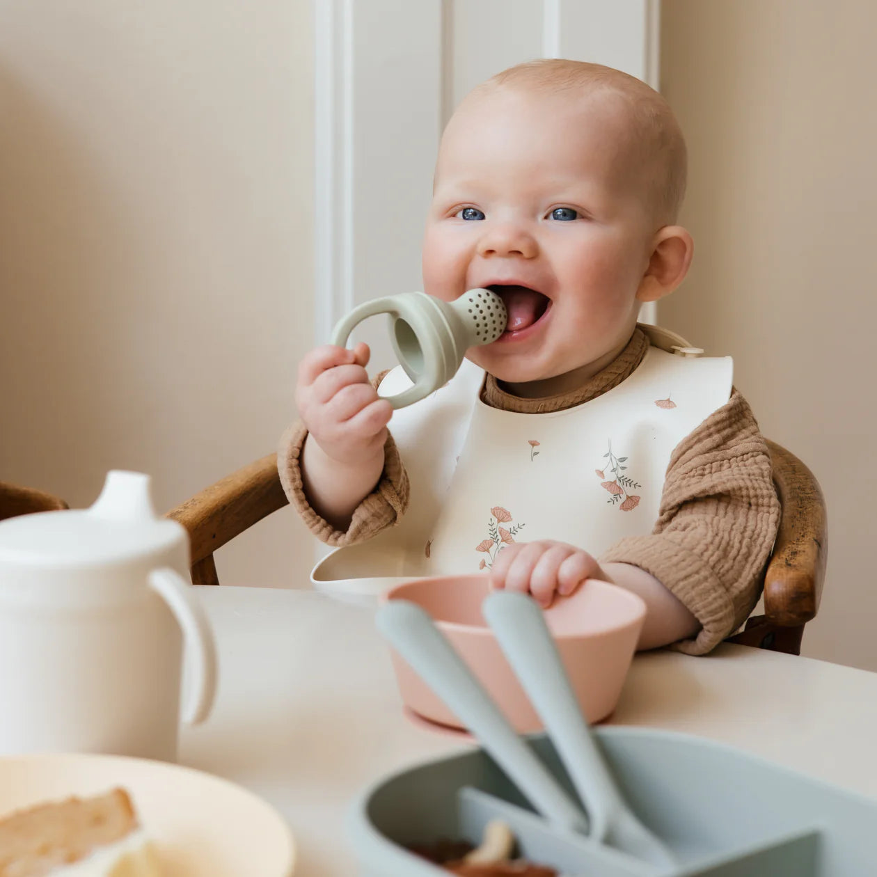 Mushie - Silicone Food Feeder - Sage - baby eating