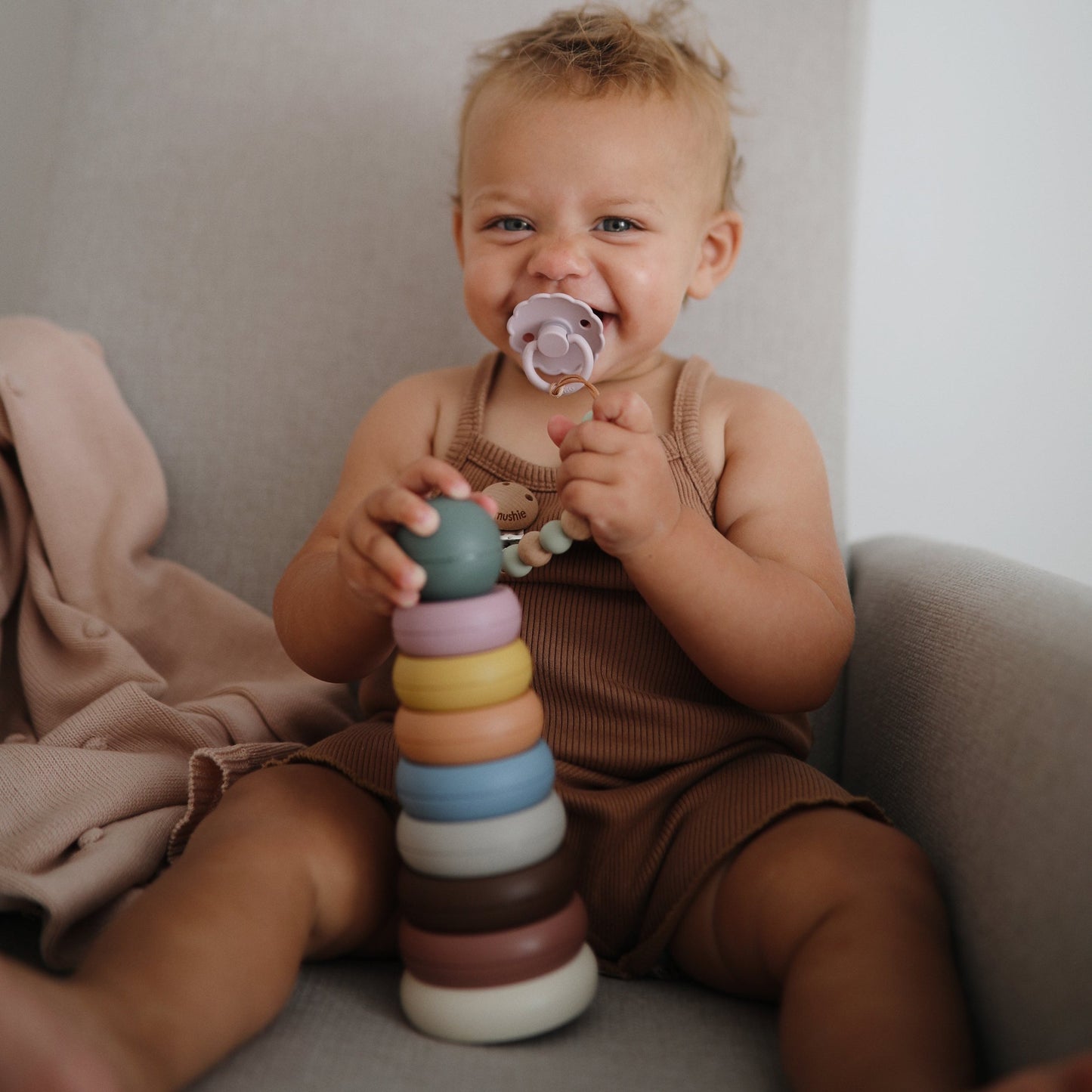 Mushie - Stacking Ring Tower - Rustic - baby playing