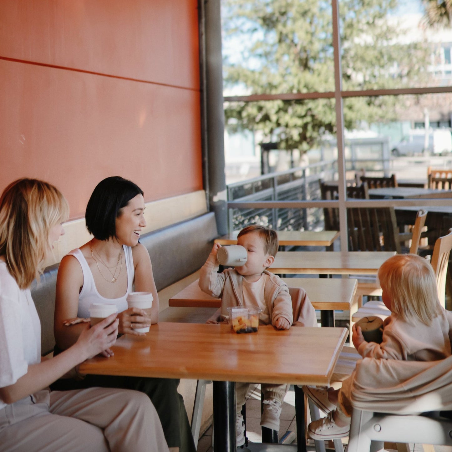 Mushie - Trainer Sippy Cup - Ivory - family in cafe