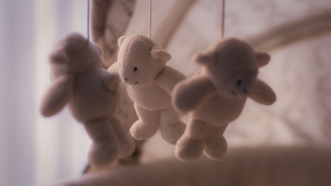 baby mobile for cot, wooden with soft teddy toys above bed