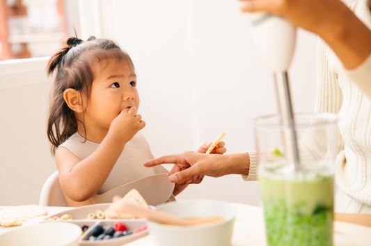 toddler in food catching silicone bib, weaning and eating solids