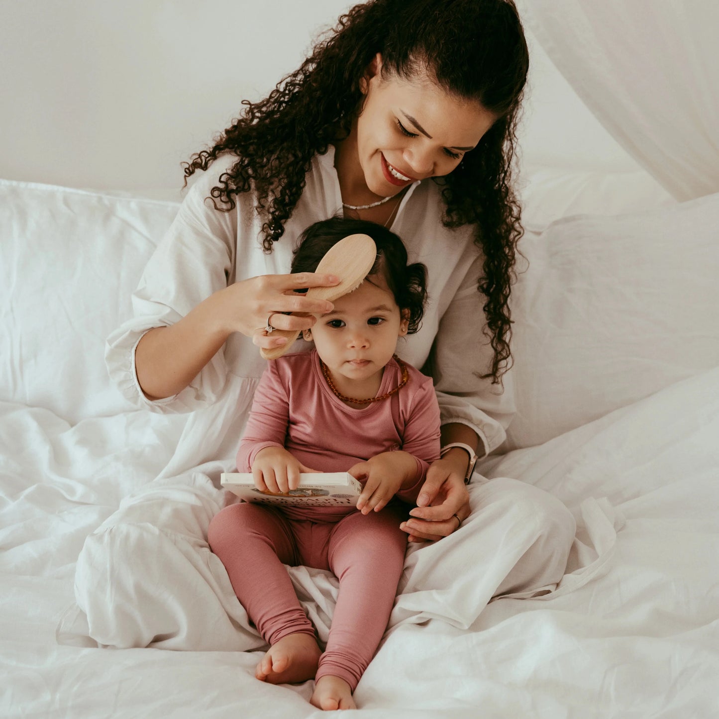Anvi Baby - Natural hairbrush set for babies and toddlers with mother brushing girls hair on bed