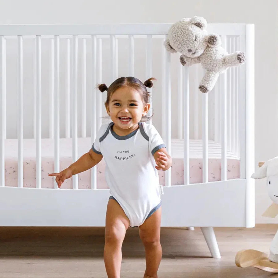 Happiest Baby SNOObear - 
 Cream Woolly - on cot