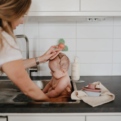 Mushie - Cradle Cap Brush - baby in sink - cradle cap