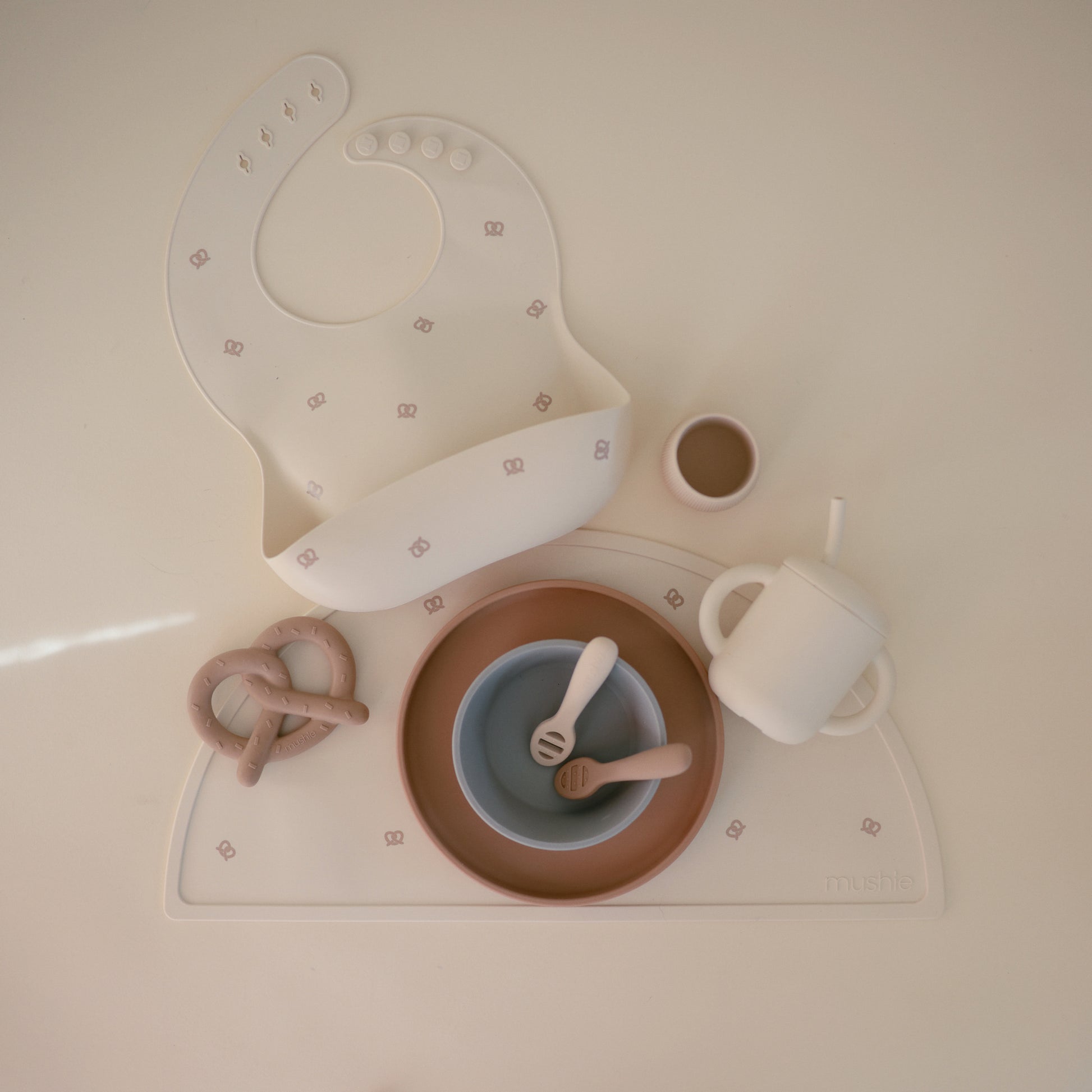 Mushie - Baby Silicone Bib - Pretzel - mat and beige accessories - toddler weaning table mat